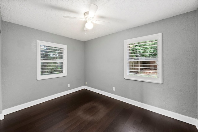 3906 W Rogers Ave, Tampa, FL 33611 - empty room featuring healthy amount of natural light, dark wood-style flooring, baseboards, a ceiling fan, and a textured wall