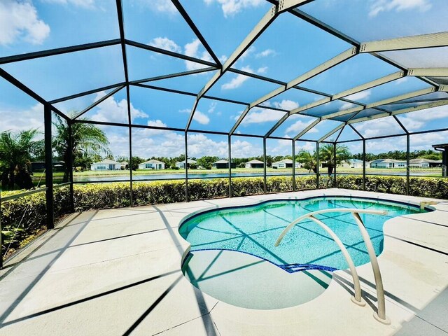 5103 98th Ave E, Parrish, FL 34219 - swimming pool featuring a patio and glass enclosure