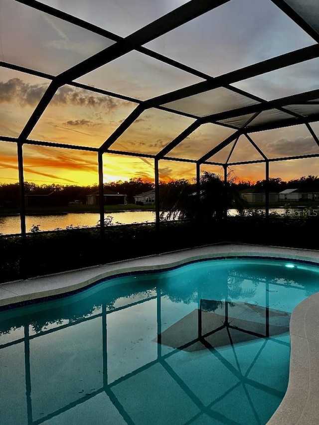 5103 98th Ave E, Parrish, FL 34219 - pool at dusk featuring an outdoor pool and glass enclosure