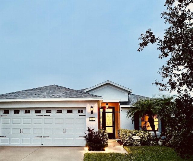 5103 98th Ave E, Parrish, FL 34219 - single story home featuring a garage, concrete driveway, a shingled roof, and stucco siding