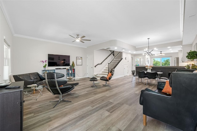 340 1st St N Unit I, Saint Petersburg, FL 33701 - living area with light wood-style floors, stairs, a chandelier, ornamental molding, and a ceiling fan