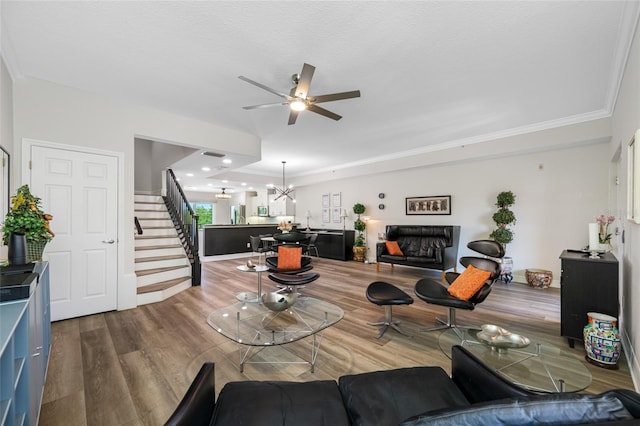 340 1st St N Unit I, Saint Petersburg, FL 33701 - living area featuring stairs, wood finished floors, ceiling fan, ornamental molding, and a chandelier
