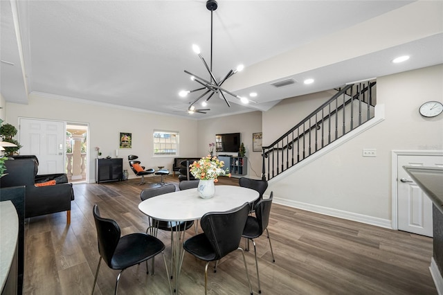340 1st St N Unit I, Saint Petersburg, FL 33701 - dining space with a chandelier, ornamental molding, wood finished floors, stairway, and baseboards