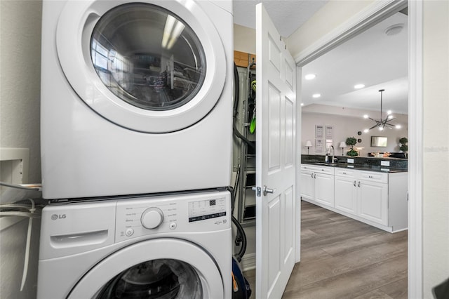 340 1st St N Unit I, Saint Petersburg, FL 33701 - washroom with stacked washer / drying machine, wood finished floors, and recessed lighting