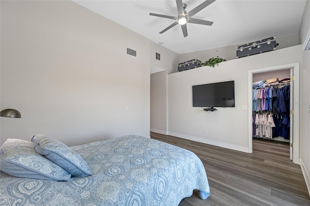 340 1st St N Unit I, Saint Petersburg, FL 33701 - bedroom featuring wood finished floors, a walk in closet, baseboards, ceiling fan, and a closet