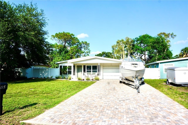 135 Emerald Ln, Largo, FL 33771 - ranch-style home featuring decorative driveway and an attached garage