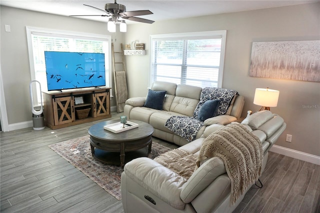 135 Emerald Ln, Largo, FL 33771 - living area featuring wood finished floors, a ceiling fan, baseboards, and plenty of natural light