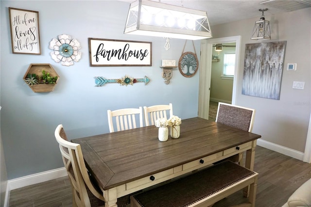 135 Emerald Ln, Largo, FL 33771 - dining area with baseboards and wood finished floors