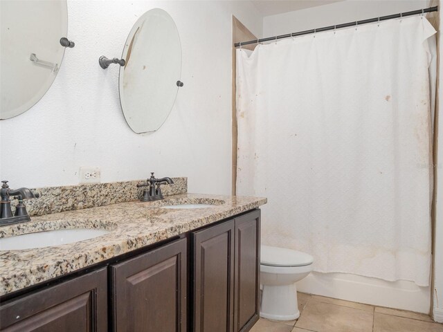 bathroom featuring double vanity, tile patterned floors, and shower / tub combo with curtain