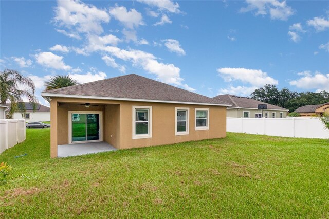 rear view of house with stucco siding, a patio, a ceiling fan, and roof with shingles