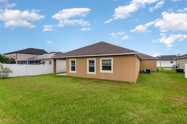 back of property featuring stucco siding and roof with shingles