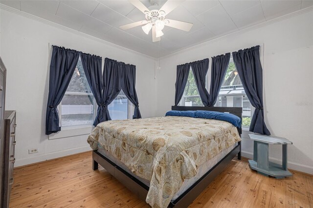 1235 Bass Blvd, Dunedin, FL 34698 - bedroom featuring ornamental molding, light wood-style floors, baseboards, and ceiling fan