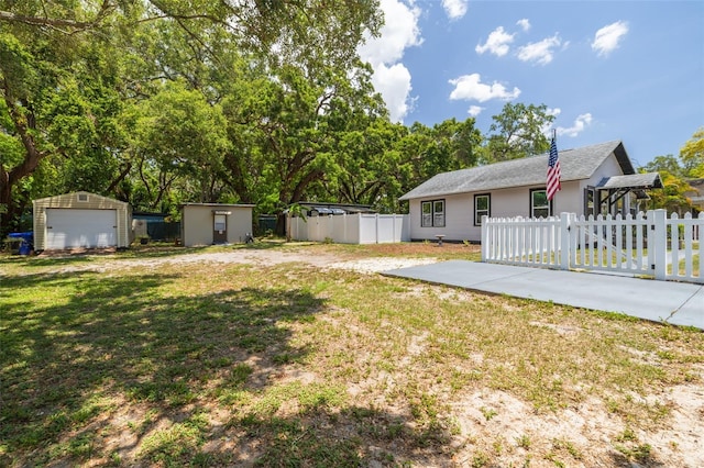 1235 Bass Blvd, Dunedin, FL 34698 - view of yard with an outdoor structure and a garage