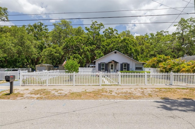 1235 Bass Blvd, Dunedin, FL 34698 - view of front of house with a fenced front yard and stucco siding