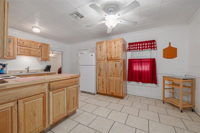 1235 Bass Blvd, Dunedin, FL 34698 - kitchen with freestanding refrigerator, ceiling fan, wooden counters, crown molding, and light brown cabinetry