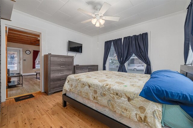 1235 Bass Blvd, Dunedin, FL 34698 - bedroom with light wood finished floors, ornamental molding, and a ceiling fan