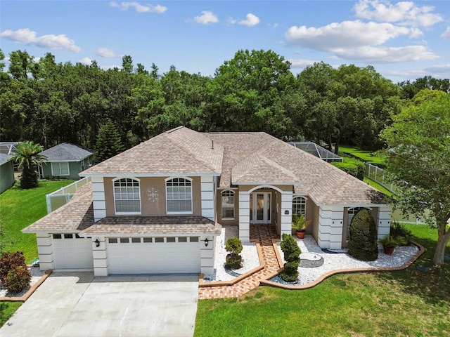 1460 Kensington Woods Dr, Lutz, FL 33549 - view of front of home featuring a shingled roof, a garage, a front yard, concrete driveway, and stucco siding