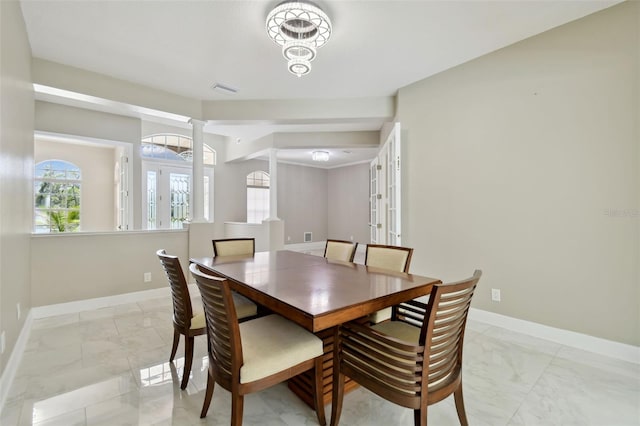 1460 Kensington Woods Dr, Lutz, FL 33549 - dining room with light marble finish flooring, ornate columns, and french doors