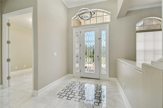 1460 Kensington Woods Dr, Lutz, FL 33549 - foyer entrance featuring plenty of natural light, ornamental molding, marble finish flooring, and a chandelier