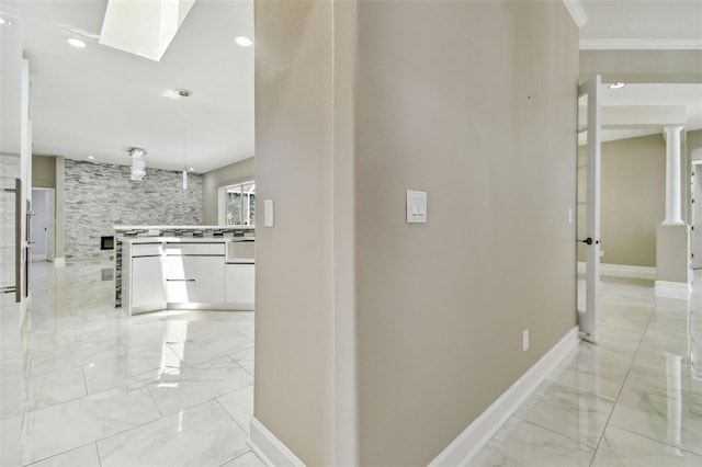 1460 Kensington Woods Dr, Lutz, FL 33549 - hall with light marble finish floors, a skylight, and crown molding