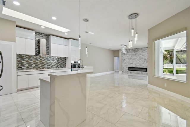 1460 Kensington Woods Dr, Lutz, FL 33549 - kitchen featuring light marble finish flooring, modern cabinets, tasteful backsplash, white cabinetry, and recessed lighting