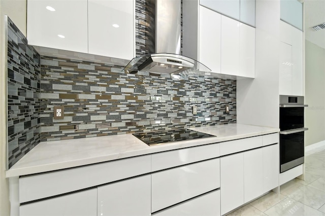 1460 Kensington Woods Dr, Lutz, FL 33549 - kitchen featuring exhaust hood, black electric stovetop, light countertops, stainless steel double oven, and recessed lighting