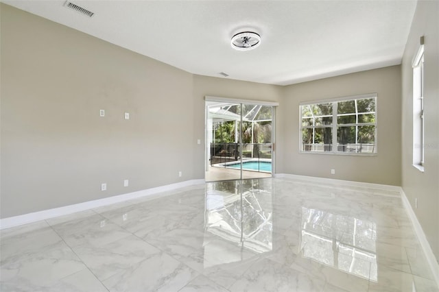 1460 Kensington Woods Dr, Lutz, FL 33549 - empty room featuring marble tiled floors and baseboards
