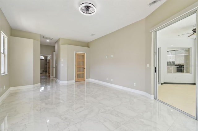 1460 Kensington Woods Dr, Lutz, FL 33549 - empty room with light marble finish flooring and a ceiling fan