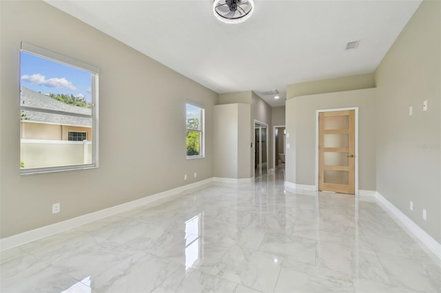 1460 Kensington Woods Dr, Lutz, FL 33549 - empty room featuring light marble finish floors and baseboards