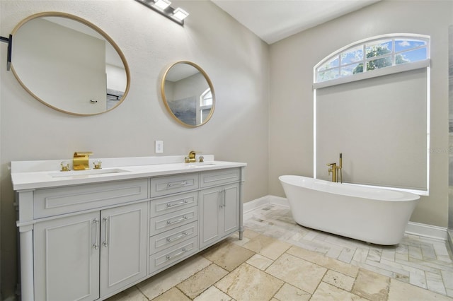 1460 Kensington Woods Dr, Lutz, FL 33549 - bathroom featuring double vanity, a soaking tub, and stone tile flooring