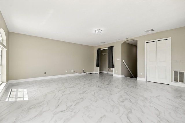 1460 Kensington Woods Dr, Lutz, FL 33549 - spare room featuring arched walkways and marble finish floors