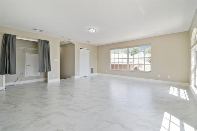 1460 Kensington Woods Dr, Lutz, FL 33549 - unfurnished living room featuring arched walkways and marble finish floors