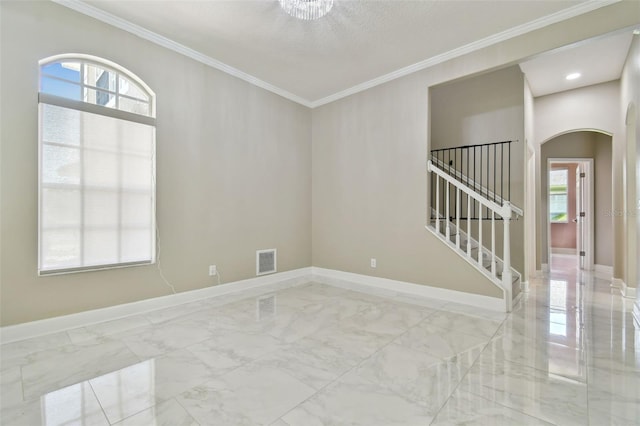 1460 Kensington Woods Dr, Lutz, FL 33549 - empty room with arched walkways, plenty of natural light, ornamental molding, stairs, and marble finish flooring