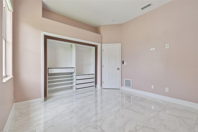 1460 Kensington Woods Dr, Lutz, FL 33549 - unfurnished bedroom featuring light marble finish flooring and a closet