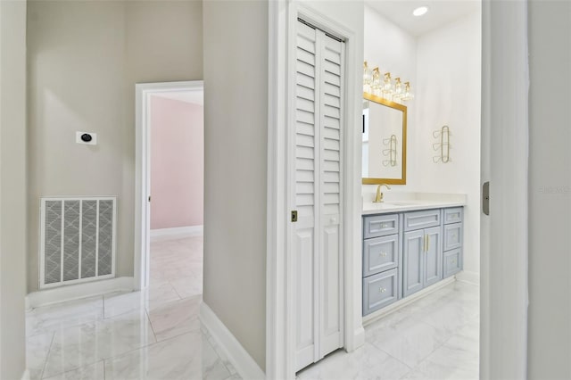 1460 Kensington Woods Dr, Lutz, FL 33549 - bathroom featuring marble look tile flooring, vanity, and a closet
