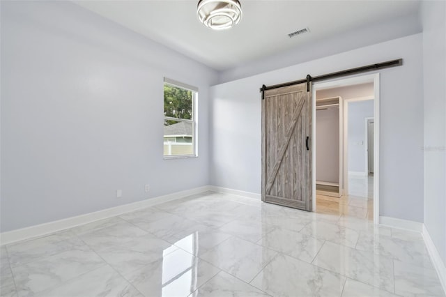 1460 Kensington Woods Dr, Lutz, FL 33549 - unfurnished bedroom with light marble finish flooring and a barn door