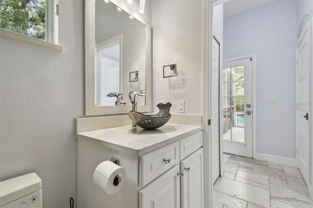 1460 Kensington Woods Dr, Lutz, FL 33549 - bathroom featuring stone tile flooring and vanity