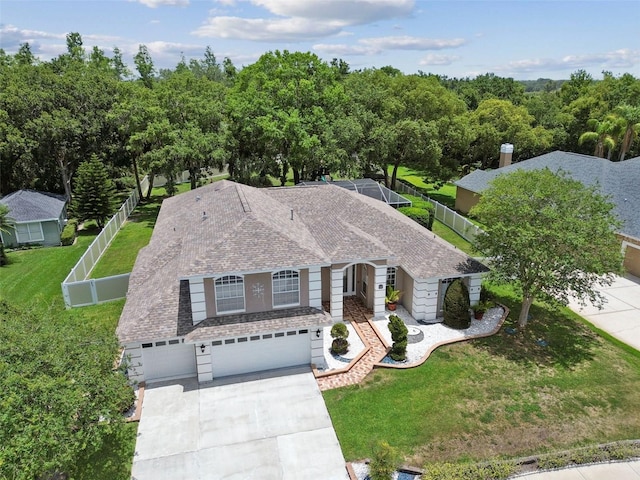 1460 Kensington Woods Dr, Lutz, FL 33549 - view of front of home with driveway, an attached garage, and a shingled roof