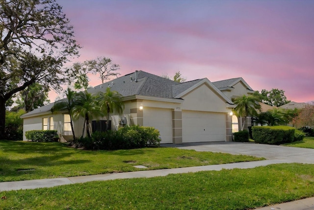 1852 Longview Ln, Tarpon Springs, FL 34689 - single story home with an attached garage, driveway, stucco siding, a yard, and roof with shingles