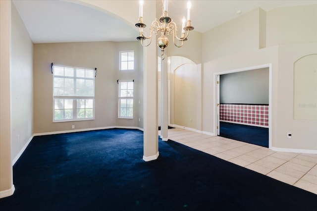 1852 Longview Ln, Tarpon Springs, FL 34689 - unfurnished room with carpet, baseboards, arched walkways, a chandelier, and high vaulted ceiling