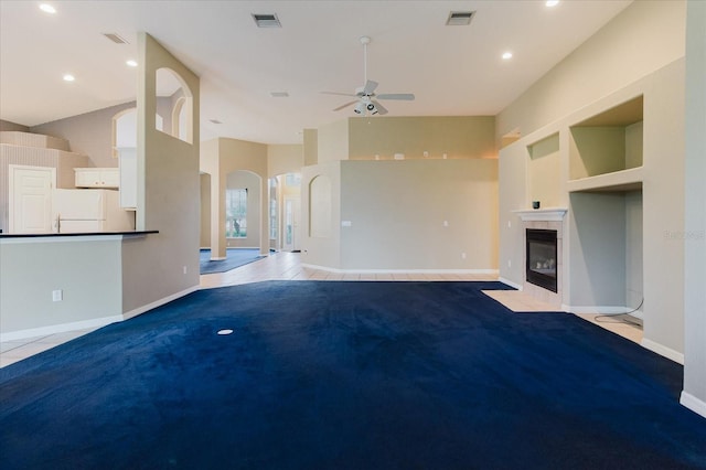 1852 Longview Ln, Tarpon Springs, FL 34689 - unfurnished living room with light colored carpet, a ceiling fan, arched walkways, a fireplace, and baseboards