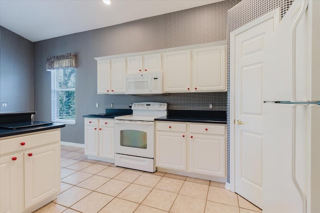 1852 Longview Ln, Tarpon Springs, FL 34689 - kitchen featuring white appliances, light tile patterned flooring, and white cabinets