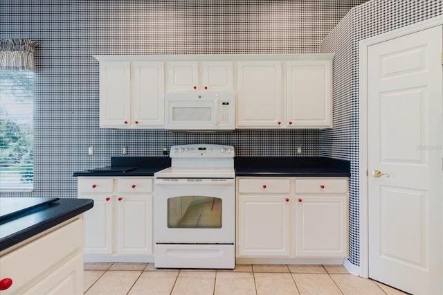 1852 Longview Ln, Tarpon Springs, FL 34689 - kitchen with white appliances, light tile patterned floors, and dark countertops