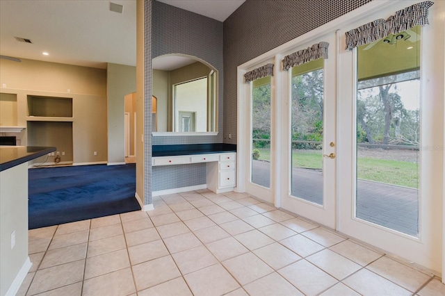 1852 Longview Ln, Tarpon Springs, FL 34689 - entryway featuring light tile patterned flooring, built in shelves, baseboards, and recessed lighting
