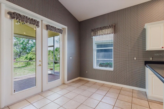 1852 Longview Ln, Tarpon Springs, FL 34689 - doorway to outside with vaulted ceiling, light tile patterned floors, and french doors