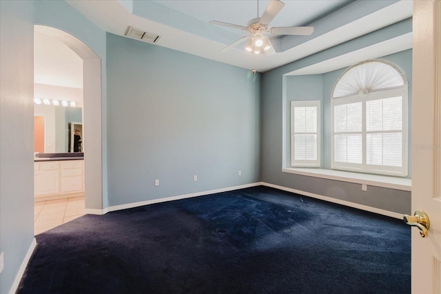 1852 Longview Ln, Tarpon Springs, FL 34689 - carpeted spare room featuring arched walkways, a ceiling fan, and baseboards