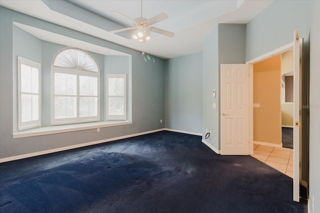 1852 Longview Ln, Tarpon Springs, FL 34689 - tiled empty room with carpet flooring, baseboards, and a ceiling fan