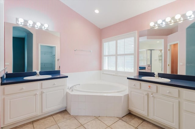 1852 Longview Ln, Tarpon Springs, FL 34689 - full bath with a stall shower, a bath, tile patterned floors, and two vanities