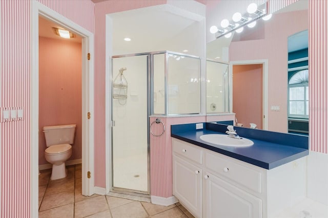 1852 Longview Ln, Tarpon Springs, FL 34689 - bathroom with toilet, a shower stall, vanity, tile patterned flooring, and wallpapered walls