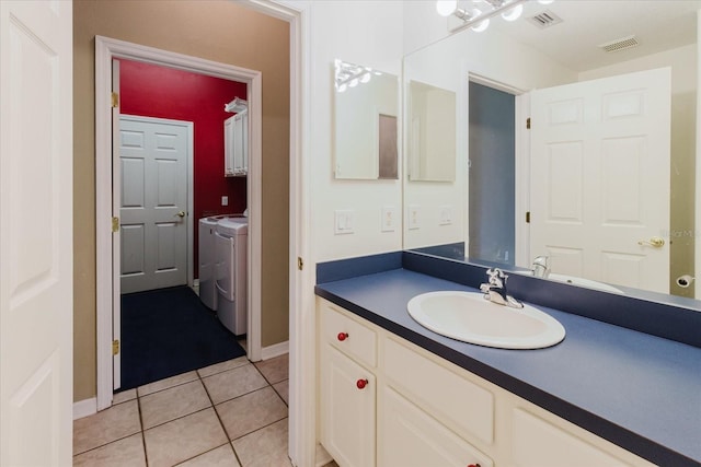1852 Longview Ln, Tarpon Springs, FL 34689 - bathroom with independent washer and dryer, vanity, tile patterned floors, and baseboards